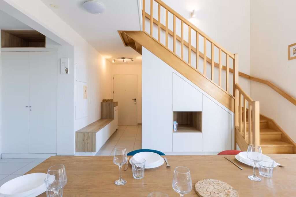 photo de l'entrée avec escalier en bois et rangement sur mesure