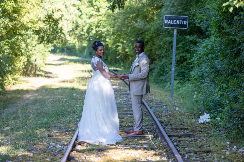 Les mariés main dans la main sur les rails, mariage en Seine-et-Marne