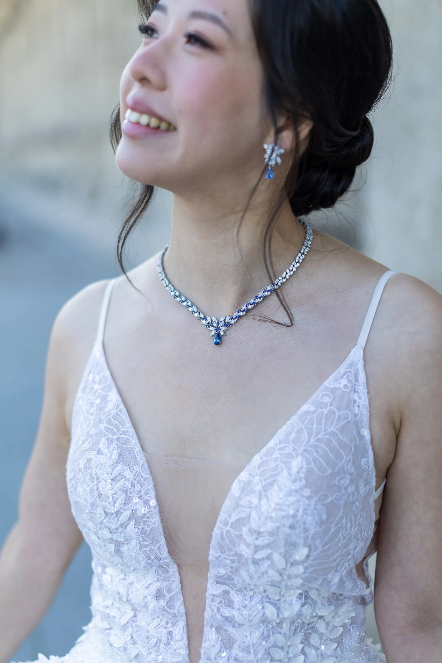 Détail de la robe de mariée en dentelle et du collier de la mariée lors de la séance Day After